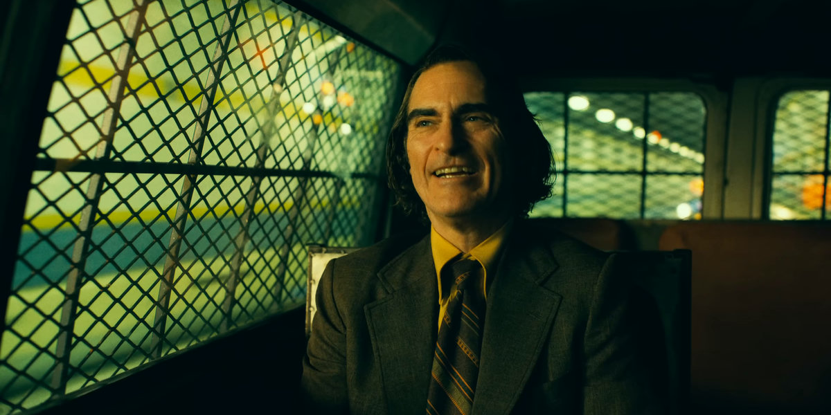 man, vehicle interior, bars, window, street lights, unsettling, disturbing, ironic, satisfied, smiling, sitting